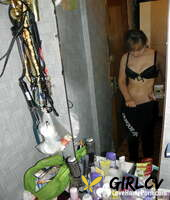 amateur girl with a nice bum stripping and posing in the mirror