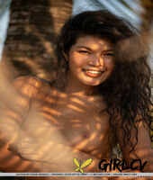 alluring thai teen kathai takes off a bikini to model in the nude under a tree48877