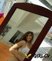 beautiful brunette karina white strips slowly in front of the mirror1394