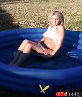 blonde teen covers her small tits in baby oil outdoors in a wading pool60886