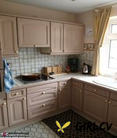 older lady cassandra uk and her lesbian lover embark on foreplay in a kitchen