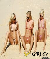 blonde girls model micro bikinis at the beach while wearing sunglasses14465