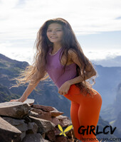 latina irene rouse poses in her yoga pants & shirt on a mountian top103292
