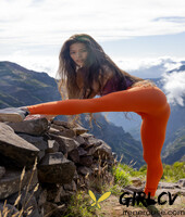 latina irene rouse poses in her yoga pants & shirt on a mountian top103294