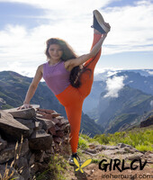 latina irene rouse poses in her yoga pants & shirt on a mountian top103289