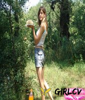 young amateur eats a cake near the woods while wearing a denim miniskirt65288