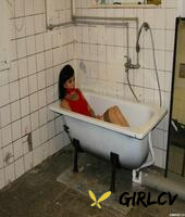 clothed brunette female is bound at wrists and ankles and left in a bathtub61902