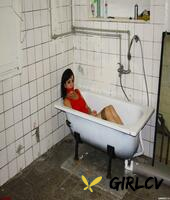 clothed brunette female is bound at wrists and ankles and left in a bathtub61897