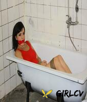 clothed brunette female is bound at wrists and ankles and left in a bathtub61898