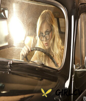 blonde classy babe ancilla tilia poses in the car with her big bosoms out